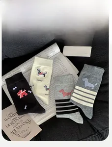 Detail of four pairs of cotton crew socks featuring cute dachshund patterns and stripes