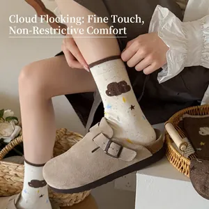 Women's cream crew socks with colorful flocking cloud patterns and khaki suede clogs