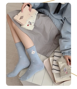 Detailed embroidery of cartoon dogs and treats on soft knit pastel cotton socks