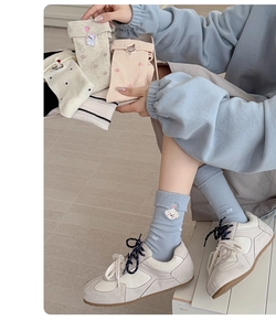 Detailed view of women's ribbed ankle socks featuring cute cartoon dog and rabbit embroidery