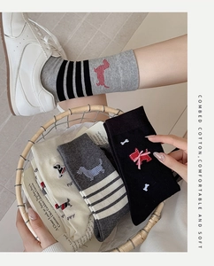 Detail of combed cotton mid-tube socks with cute dog patterns and striped designs