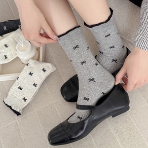 Grey crew socks with black bow prints and ruffled edges for women in autumn style
