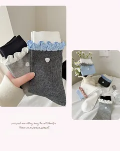 Close-up of ruffled cuff socks with heart sequin detail and color contrast design