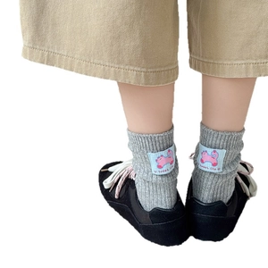 Grey wool blend crew socks with cartoon heel patch and ribbed texture for kids