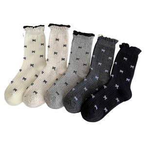 Five pack of women's knitted crew socks with bow patterns and ruffled cuffs in neutral tones