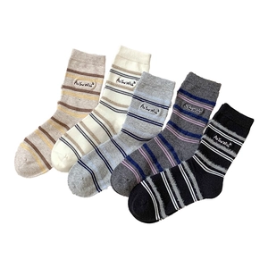 Five pairs of striped crew socks in neutral tones featuring embroidered text labels
