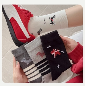 Detailed embroidery of cartoon puppy and signature stripes on cotton crew socks