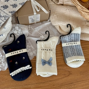 Three pairs of navy blue floral and bow mid-tube cotton socks in a gift box