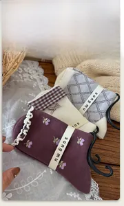 Detail of floral and argyle patterned cotton socks with lace trim on a rustic wooden table