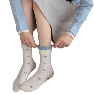 Chic white mid-calf socks with grey polka dot bows and ribbed texture for women