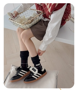Close-up of retro black sneakers with white stripes and vintage checkered mid-calf socks
