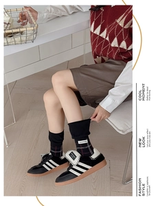 Detailed view of plaid knit socks and retro sneakers with classic white side stripes