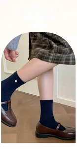 Detail of navy blue ribbed cotton socks featuring elastic rolled cuffs and Lycra fiber