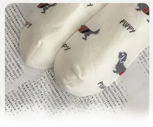 Close-up of reinforced toe design on white cotton socks with puppy pattern print