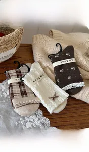 Detailed view of vintage cotton socks featuring plaid, cable knit and floral patterns