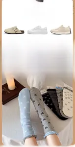 Détail de chaussettes style ballet avec motifs jacquard nœuds et bords ondulés