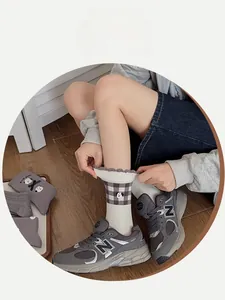 Detail showing high elasticity and cute cartoon puppy embroidery on grey plaid socks