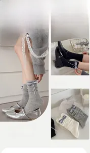Detail of ballet style calf socks with plaid bows and long ribbons in neutral tones