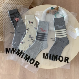 Cute cartoon puppy crew socks in four colors with striped details and puppy prints