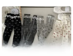 Close-up of lace trim socks with pearl accents and bow patterns in various colors