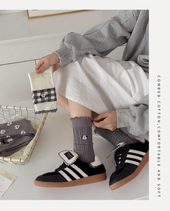 Close-up of gray cotton socks with cute dog embroidery and ruffled lettuce trim