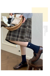Detailed knit texture and button decor on vintage style crew socks for women
