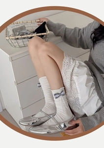 Detailed close-up of cream crew socks with gingham bow and ribbon trim ballet style