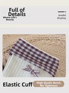 Detail of white ribbed cotton sock with purple plaid cuff and delicate bow decoration