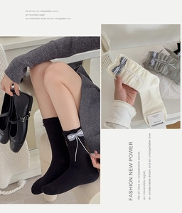 Detail of ballet style calf socks with plaid ribbon bows and ruffled edge texture