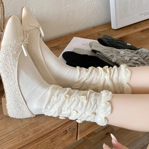 Sweet white slouch socks with 3D rose flowers and beige bow flat shoes on wood surface