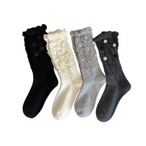 Set of four cable knit crew socks with 3D fabric rose accents and ruffled cuffs in four colors