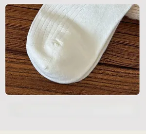 Close-up of seamless toe stitching and fine knit texture of white cotton socks