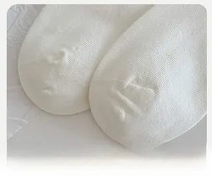 Macro view of white reinforced sock toe with high-density knitting and seamless stitching