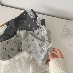 Sweet grey lace trim crew socks with pearl beads and bow pattern on wooden tray