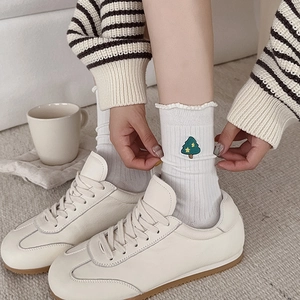 White cotton socks with Christmas tree embroidery and ribbed knit texture