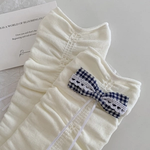 Ballet style cream knit leg warmers with blue plaid bows and white lace trim