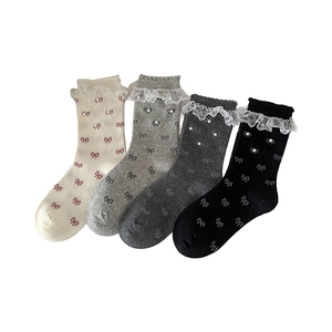 Set of four women's lace trim mid-calf socks with pearls and bow accents in neutral tones