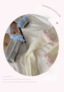 Detail of sweet ballet-style crew socks with plush lace edges and ribbed knit texture