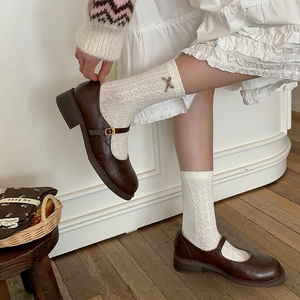 Vintage brown Mary Janes paired with white floral lace socks and bow accents