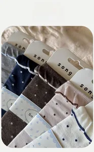Close-up of cotton mid-calf socks with retro polka dots and elegant ruffled cuffs