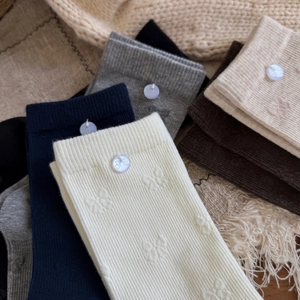 Cozy ribbed cotton socks with button and bow details in various autumn colors