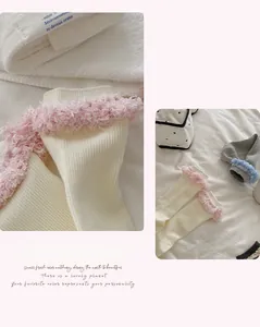 Detail of sweet ballet style ribbed mid-tube socks with soft feather lace trim accents