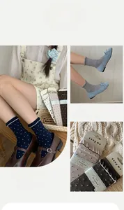 Detail of ballet style polka dot socks with ruffled edges and high-quality cotton texture