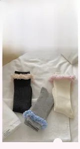 Detail of sweet ruffle lace trim socks in dark grey, light grey, and beige cotton knit