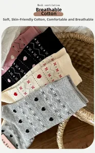 Close-up of Fair Isle knit cotton socks in pink and grey neatly arranged in a basket