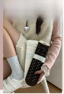 Detail of scalloped edge and 3D polka dot texture on premium cotton crew socks for women