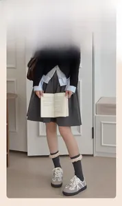 Dark grey crew socks with lace trim paired with school uniform pleated skirt and sneakers