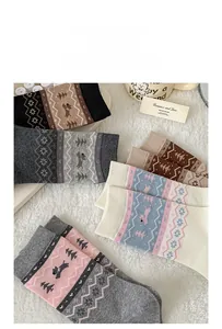 Detail of Fair Isle pattern combed cotton socks featuring cute dog and snowflake motifs