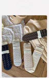 Detailed knit texture of vintage polka dot cotton socks in five classic autumn colors