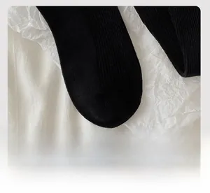 Detail of black cotton socks featuring smooth flat-toe seams and fine knit texture